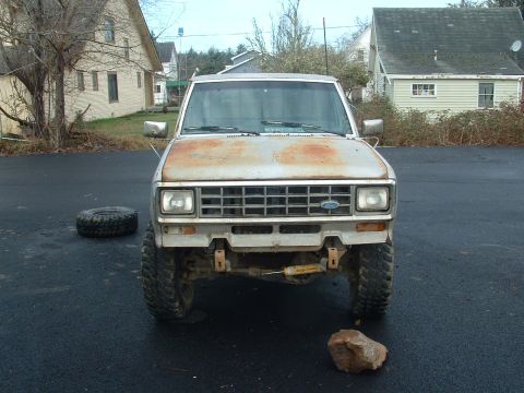 1983 Ford Ranger - A 1983 Ford Ranger pickup truck is shown from the front, parked on an asphalt surface.