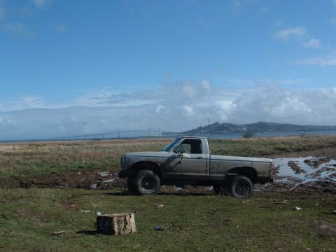 1983 Ford Ranger - This 1983 Ford Ranger is parked in a muddy field under a partly cloudy sky.
