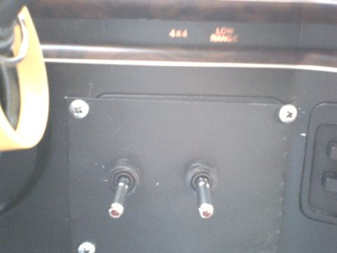 1989 Ford Bronco - Dashboard view showing toggle switches and illuminated 4x4 and Low Range indicators.