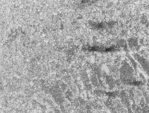 1980 Ford F-250 - Microscopic view of metal grain structure, likely from a metallurgical sample.