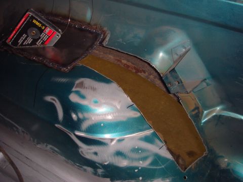 1996 Ford Bronco - A section of the vehicle's floor is cut out and prepped for repair, with a grinding disc visible.