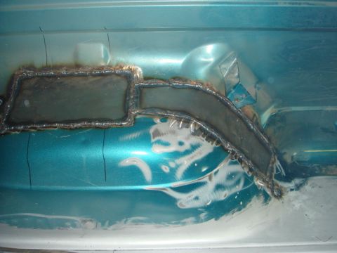 1996 Ford Bronco - Welded metal patch repairs rust damage on the interior floor of a 1996 Ford Bronco.