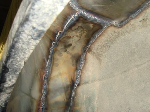 1996 Ford Bronco - Close-up view of welded metal repairs, showing the texture and color variations from the welding process.