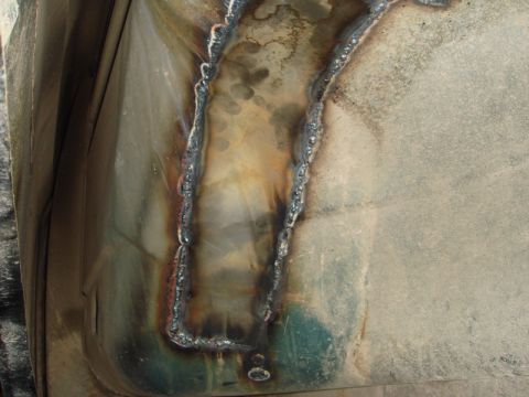 1996 Ford Bronco - Close-up view of a floor repair showing welded seams and metal surface.