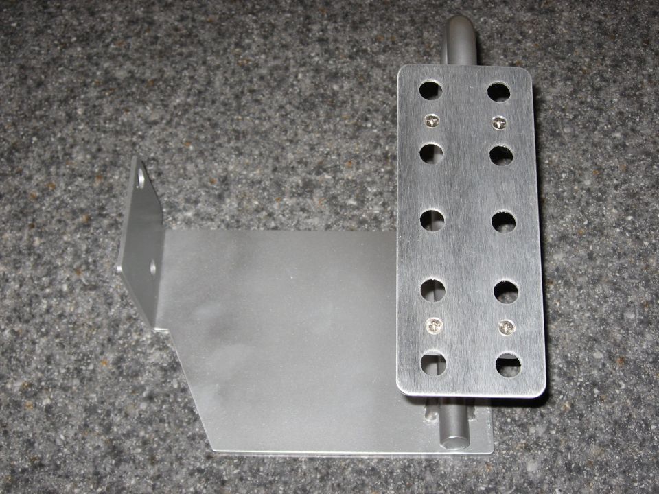 Metal bracket with drilled holes viewed from the side