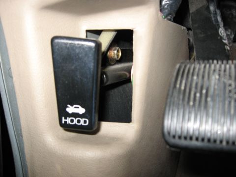 2001 Ford Crown Victoria - Step 2: Remove hood release hole cover.