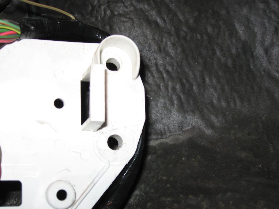 Step 5: Cut white bracket (after). I have yet to trim the lower edge of the bracket when this picture was taken. Trimming the lower edge allows the bracket to NOT contact the pedal baseplate when installed.