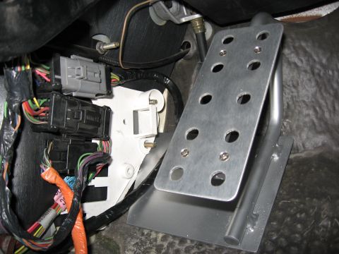 2001 Ford Crown Victoria - Step 6: Install plate behind white bracket and reuse the 10mm nut on the top bolt.