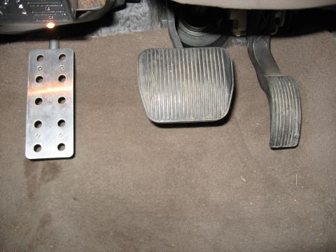 2001 Ford Crown Victoria - Step 7: Put carpet back. Re-install trim panel, hood release cover, and weatherstripping.