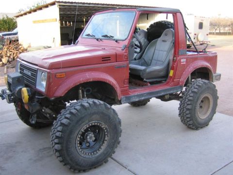 1987 Suzuki Samurai - Modified 1987 Suzuki Samurai with off-road tires and lifted suspension, doors removed.