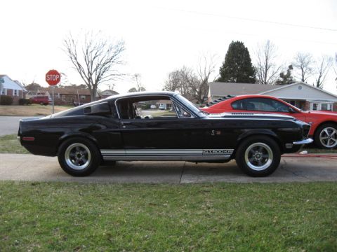 1968 Shelby GT500 - A black 1968 Shelby GT500KR is parked next to a red car.