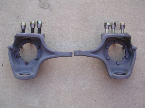 1999 Toyota Tacoma - Two steering knuckles are shown laid out on a concrete surface.