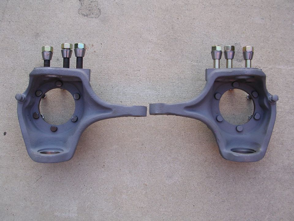Pair of gray steering knuckles with bolts installed