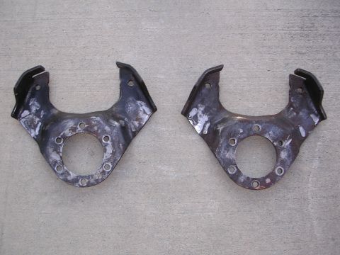 1999 Toyota Tacoma - A pair of used suspension knuckles are shown laid out on a concrete surface.