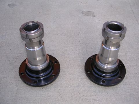 1999 Toyota Tacoma - A pair of front axle hubs are displayed on a concrete surface, likely for sale or installation.