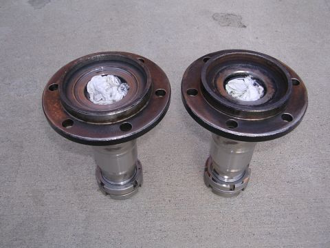 1999 Toyota Tacoma - Two wheel hubs, each stuffed with white cloth, are displayed on a gray concrete floor.