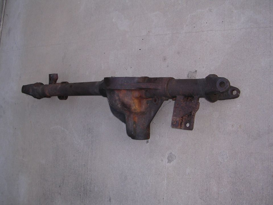 Rusted differential axle housing, likely from an older truck