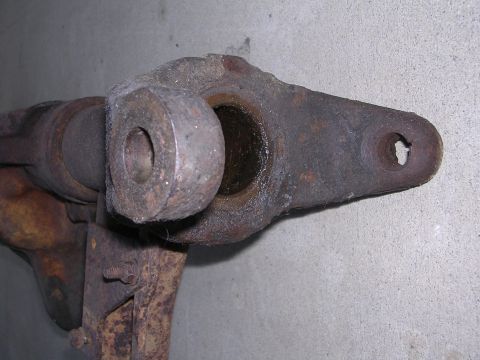 1999 Toyota Tacoma - This heavily rusted metal part shows signs of wear and is likely a component from a vehicle's suspension system.