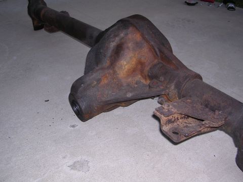 1999 Toyota Tacoma - This is a rusty differential axle housing with a drive shaft, likely a spare part.