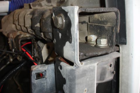 1996 Ford Bronco - Close-up view of a vehicle's frame and mounting bracket, with visible wiring and bolts.