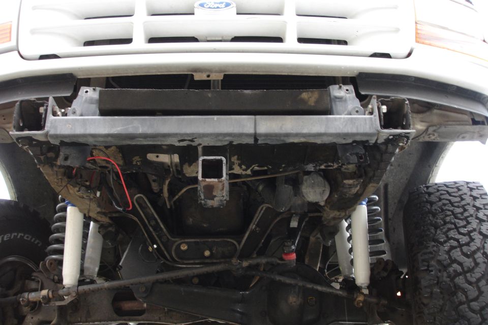 1996 Ford Bronco front undercarriage with visible hitch receiver and suspension components