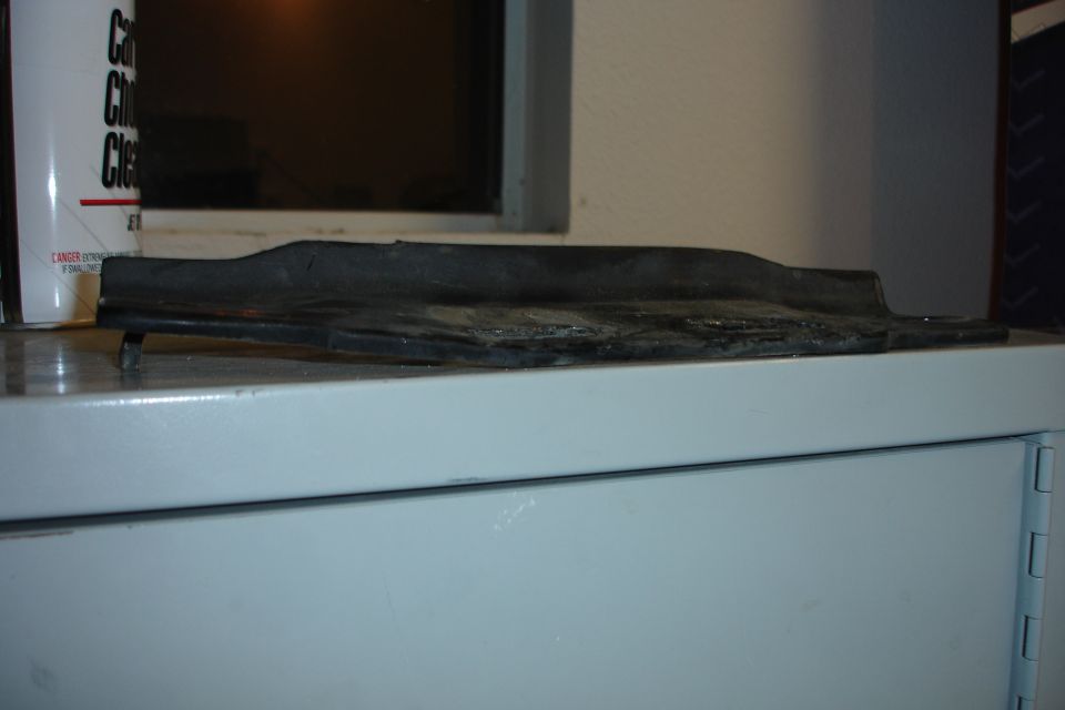 Black rubber trim piece on a shelf