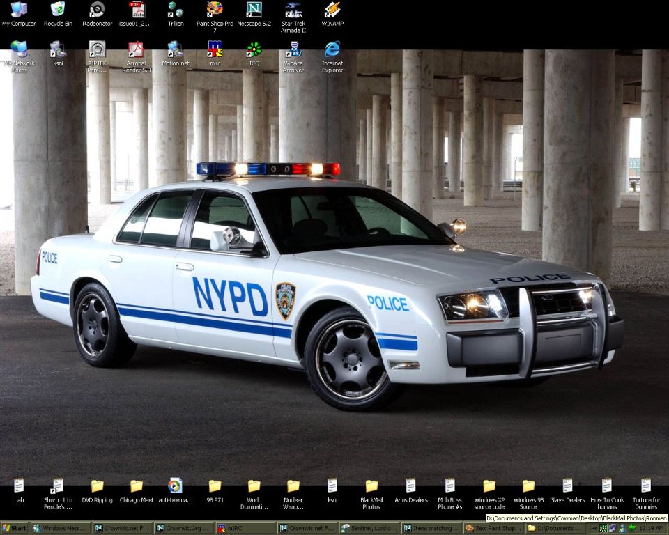 Windows desktop with wallpaper of white NYPD Crown Victoria police car