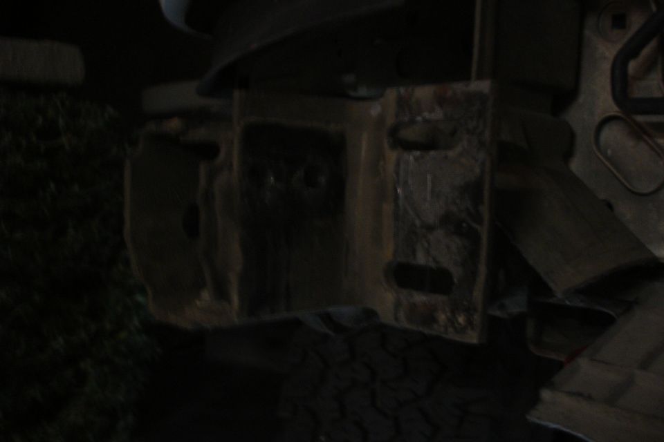 rusted metal bracket with rectangular cutouts