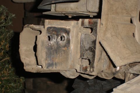 1996 Ford Bronco - This photo shows a close-up view of a vehicle's bumper mounting bracket, which appears to be heavily corroded.