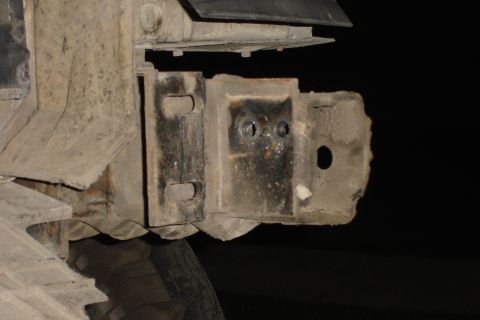 1996 Ford Bronco - Close-up view of a heavily rusted bumper bracket, showing signs of wear and tear.