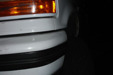1996 Ford Bronco - Front bumper and turn signal detail of an unidentified white vehicle.