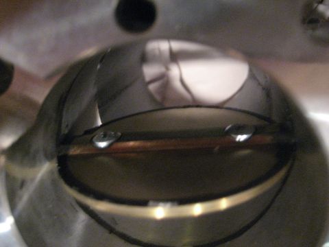 1989 Ford Bronco - Close-up view inside a throttle body, showing the butterfly valve and mounting screws.