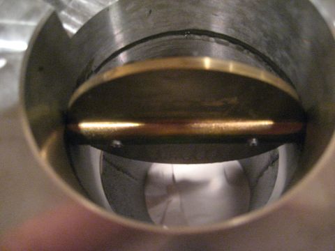 1989 Ford Bronco - Internal view of a throttle body, showing the butterfly valve and its mounting screws.