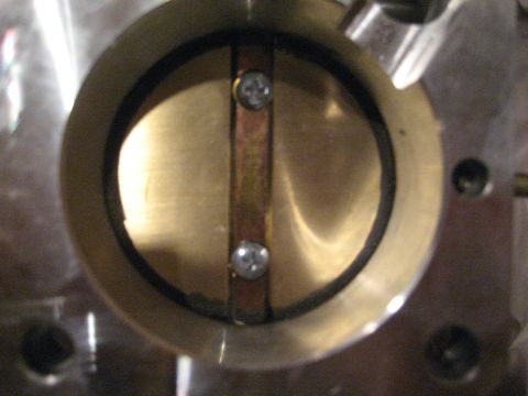 1989 Ford Bronco - This is a close-up view of a throttle body, showing the butterfly valve mechanism.