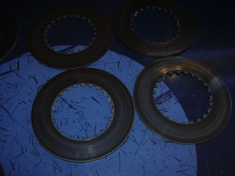 1996 Ford Crown Victoria - Four differential clutch packs are shown on a blue surface with a watermark.