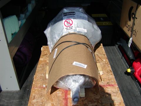 1989 Ford Bronco - A transmission is packaged for shipping, with caution labels visible.