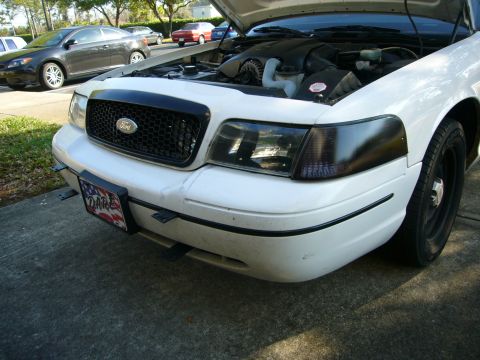 2000 Ford Crown Victoria - Front view of a 2000 Ford Crown Victoria with the hood open, parked outdoors.