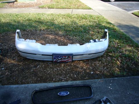 2000 Ford Crown Victoria - Front bumper and grille assembly for a Ford Crown Victoria, possibly from a 2000 model year.