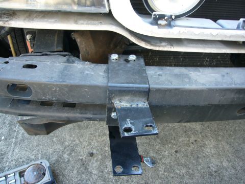 2000 Ford Crown Victoria - A close-up view of a Go Rhino push bumper mounting bracket attached to a vehicle's front end.