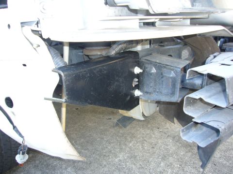 2000 Ford Crown Victoria - Close-up view of a black Go Rhino Push Bumper attached to the front frame of a vehicle.