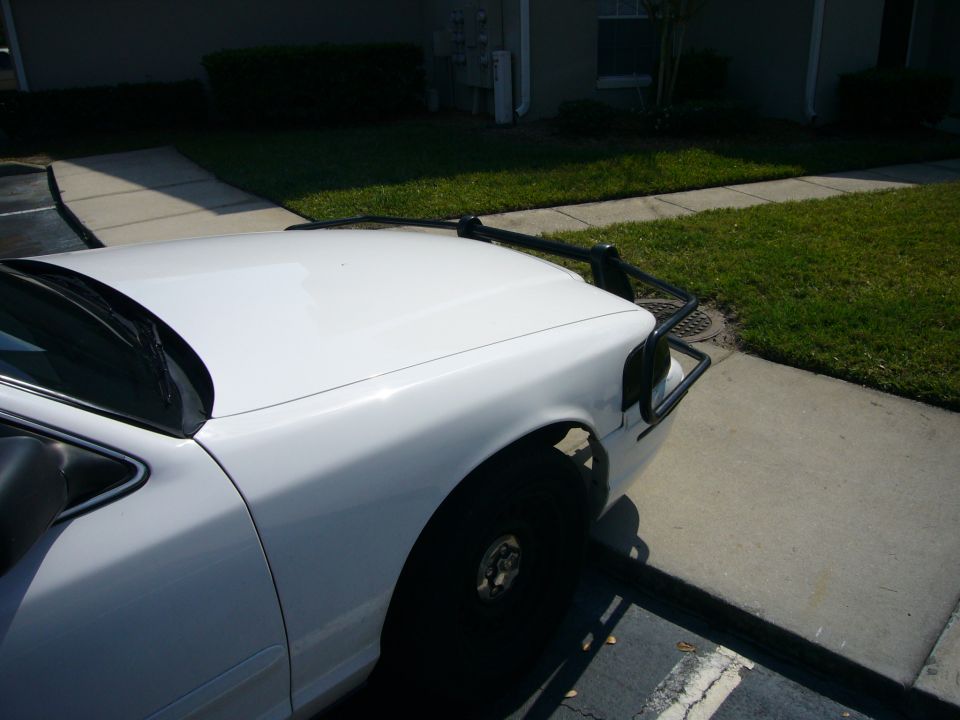 White 2000 Ford Crown Victoria front quarter view with a black push bumper installed