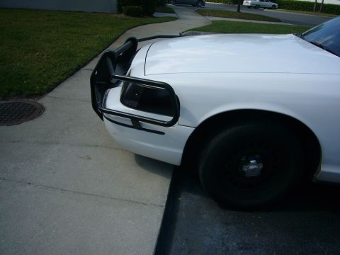 2000 Ford Crown Victoria - Front view of a white police car equipped with a Go Rhino push bumper.