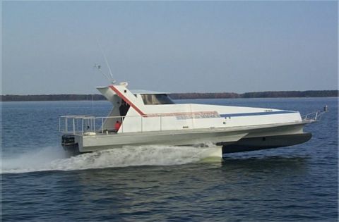1978 Ford F-250 - A white catamaran boat with red and blue accents speeds across the water, leaving a foamy wake behind it.