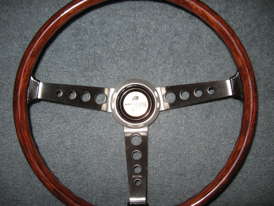 Wood and metal steering wheel with Shelby Cobra logo