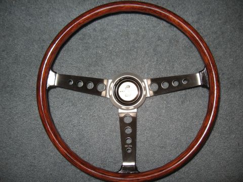 1968 Shelby GT500 - Wood rim steering wheel with polished metal spokes and a central cobra emblem.