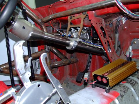 1990 Ford Mustang - Interior view of a custom race car, highlighting modifications like a roll cage and shifter mechanism.