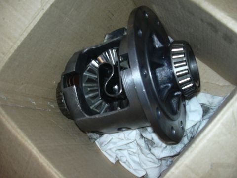 1996 Ford Crown Victoria - A differential carrier with internal gears and a bearing is shown inside a cardboard box.