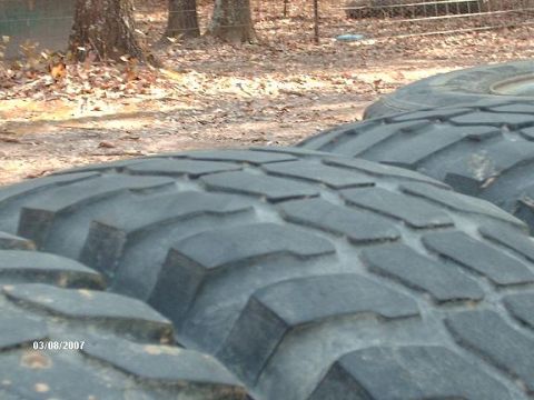 1990 Ford F-150 - Several large off-road tires are shown, with the tread pattern prominently displayed. The Supermotors.net logo is visible in the lower righ…