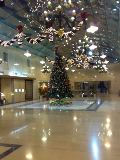 1999 Mercury Grand Marquis - A large Christmas tree is decorated in a lobby with festive lights and garlands overhead.