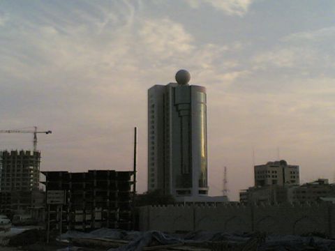 1999 Mercury Grand Marquis - Construction and city buildings under a hazy sky.